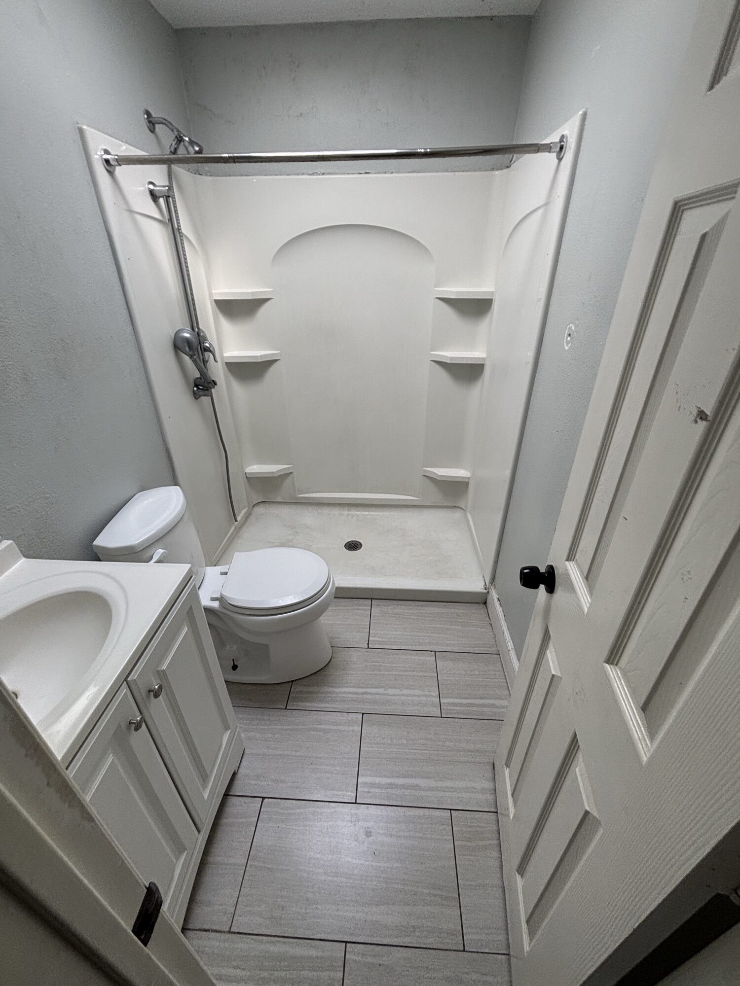 Original Fallbrook bathroom before OSR interior demolition — shower stall, toilet, vanity and tile still in place